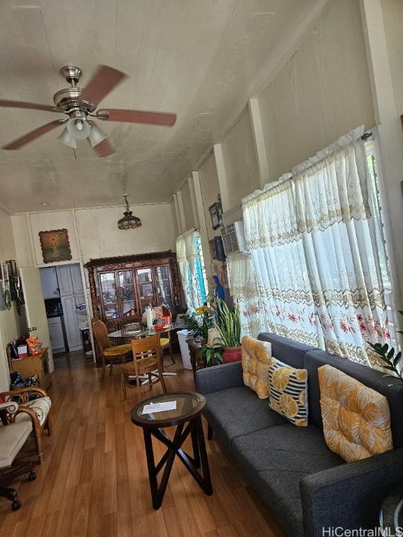 living room featuring hardwood / wood-style flooring and ceiling fan