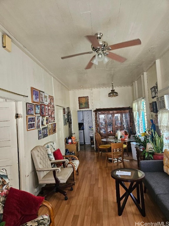 living room featuring hardwood / wood-style floors and ceiling fan