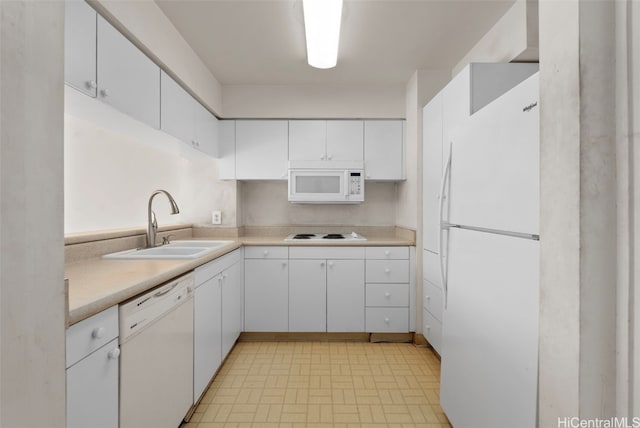 kitchen with sink, white cabinetry, and white appliances