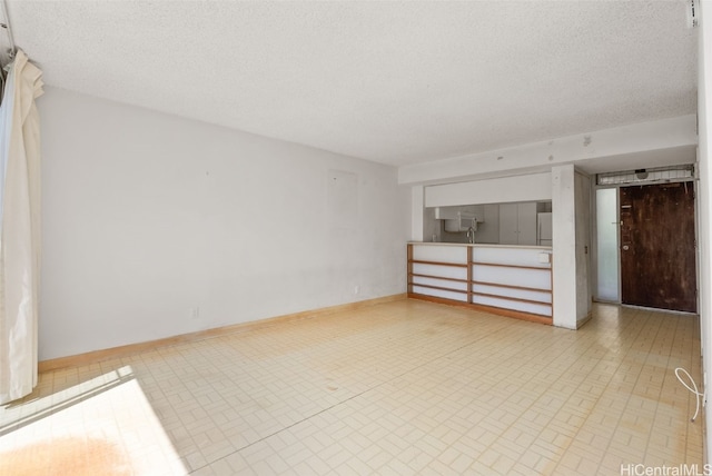 unfurnished living room with a textured ceiling