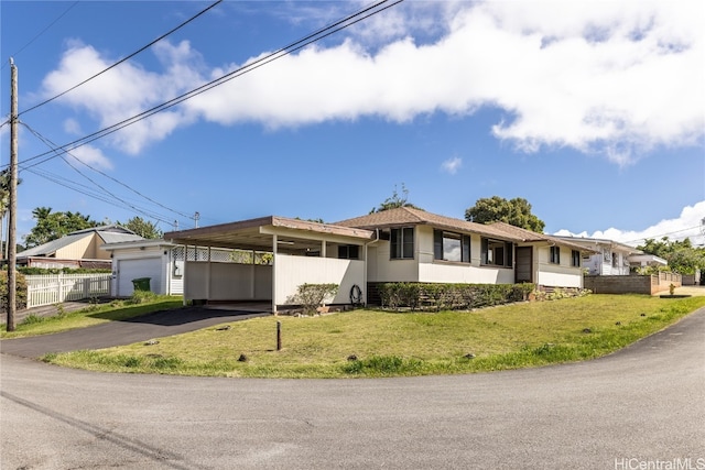 ranch-style house with a front lawn and a carport