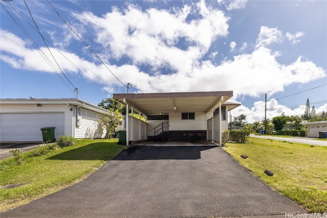 view of front facade featuring a carport, a front yard, and a garage