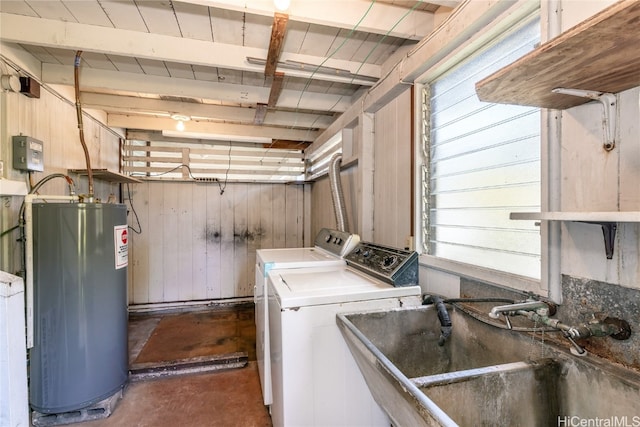 washroom featuring independent washer and dryer, sink, water heater, and wooden walls