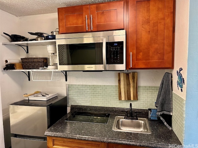 kitchen with sink, decorative backsplash, a textured ceiling, and black electric cooktop