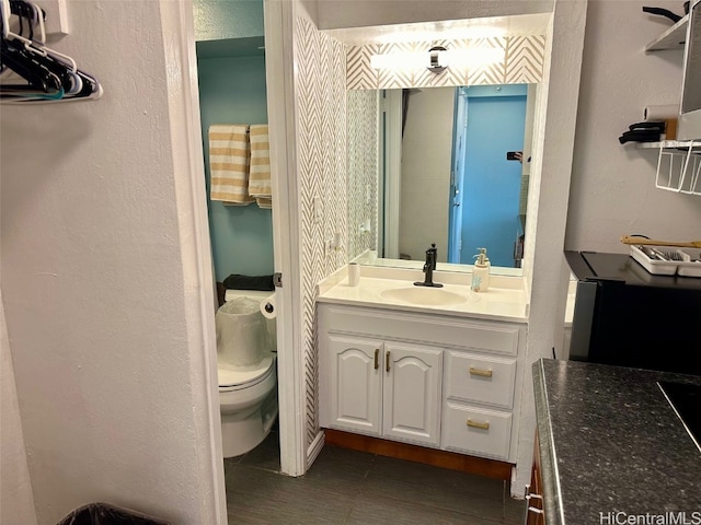 bathroom with vanity and toilet