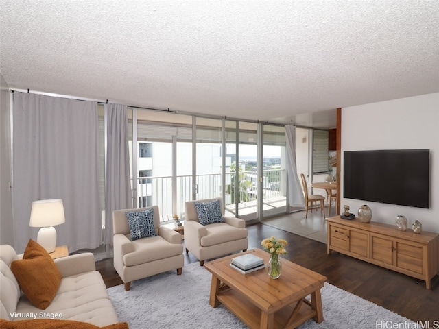 living room featuring a textured ceiling, floor to ceiling windows, and dark hardwood / wood-style flooring