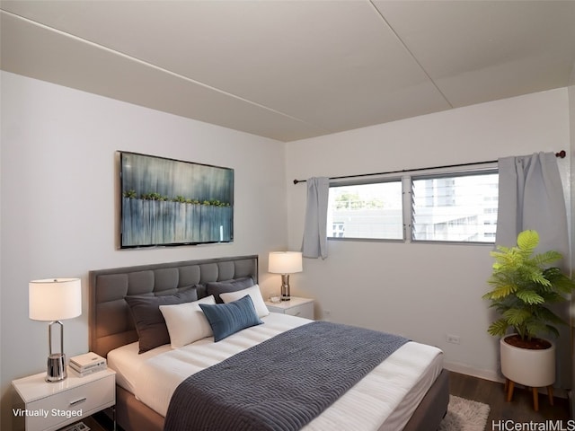 bedroom with dark hardwood / wood-style floors