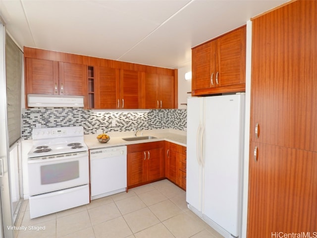 kitchen with sink, light tile patterned floors, backsplash, and white appliances