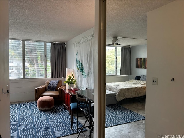 bedroom featuring parquet flooring and a textured ceiling