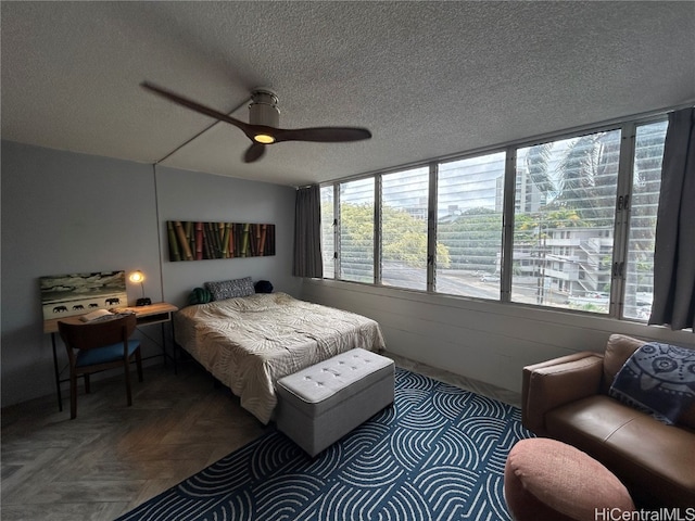 bedroom with parquet flooring, multiple windows, a textured ceiling, and ceiling fan