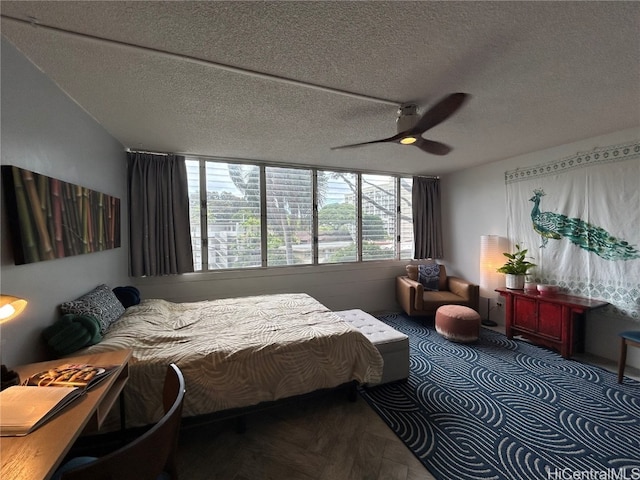 bedroom featuring ceiling fan and a textured ceiling