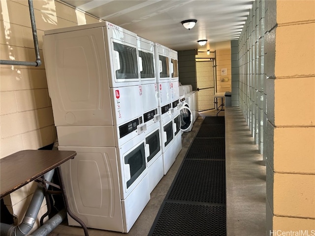 laundry area with stacked washing maching and dryer