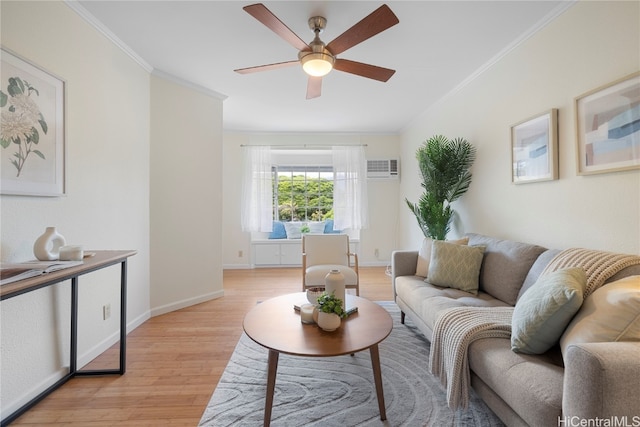 living room with light hardwood / wood-style floors, ornamental molding, a wall unit AC, and ceiling fan