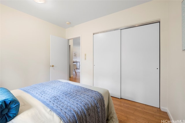 bedroom with a closet and hardwood / wood-style flooring