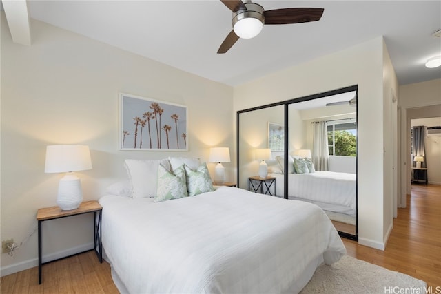 bedroom with a closet, ceiling fan, and light hardwood / wood-style flooring