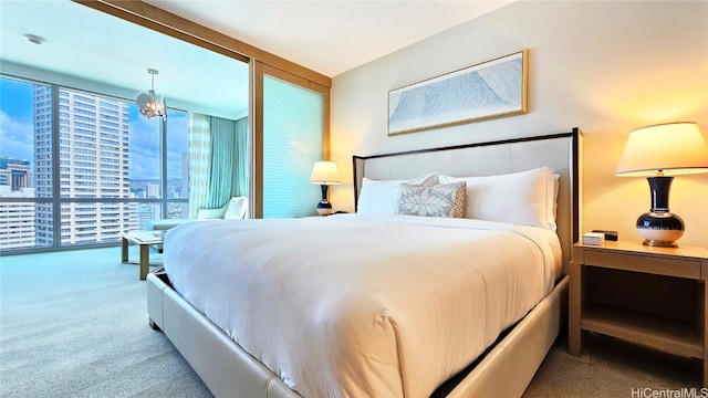 bedroom with carpet floors and floor to ceiling windows