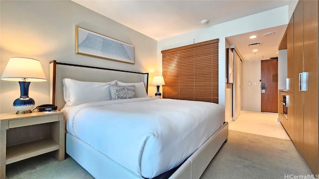 bedroom with light carpet and wood walls