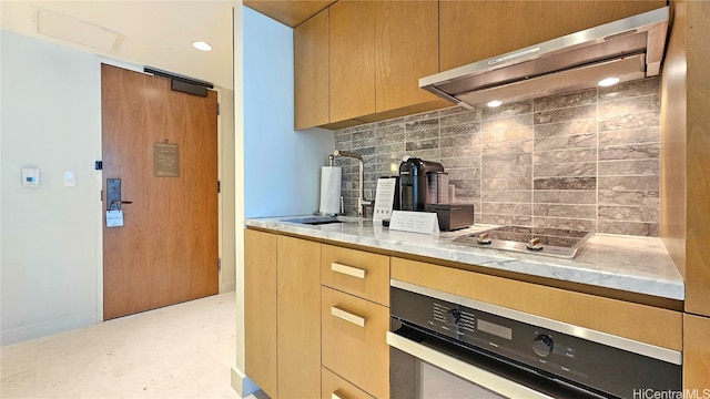 kitchen featuring sink, ventilation hood, decorative backsplash, and oven