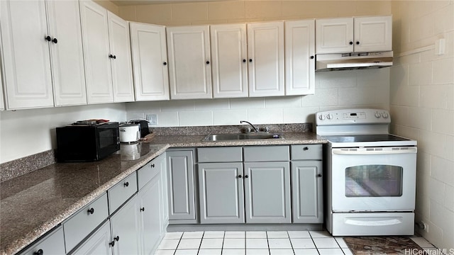 kitchen featuring gray cabinetry, electric range, sink, and white cabinets