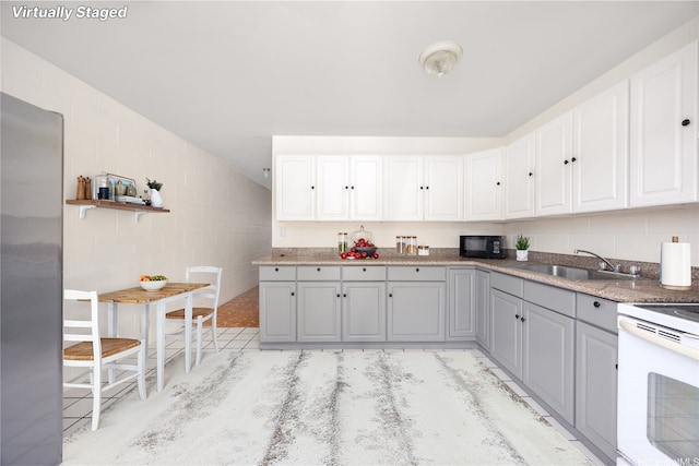 4280 Salt Lake Blvd Unit H11, Honolulu, HI 96818 - kitchen featuring electric range, gray cabinets, tile walls, stainless steel refrigerator, and black microwave