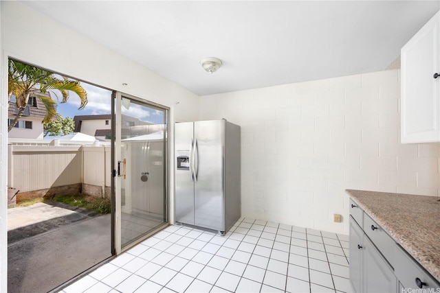 4280 Salt Lake Blvd Unit H11, Honolulu, HI 96818 - kitchen with stainless steel fridge, light countertops, white cabinets, and light tile patterned floors