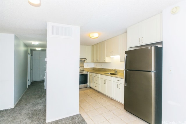 kitchen featuring light carpet, stainless steel appliances, white cabinetry, and sink