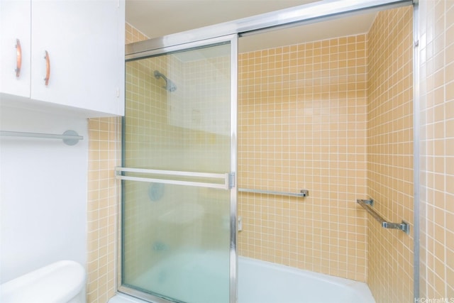 1561 Kanunu St Unit 1205, Honolulu, HI 96814 - bathroom featuring toilet and shower / bath combination with glass door