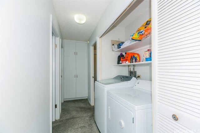 laundry room featuring light carpet, a textured ceiling, and washing machine and clothes dryer