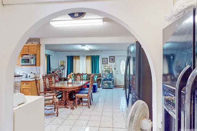 92-746 Palailai St, Kapolei, HI 96707 - dining area with light tile patterned floors, a textured ceiling, and arched walkways