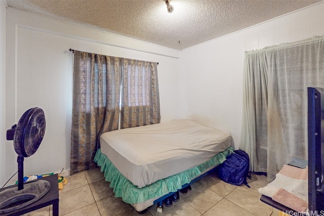 tiled bedroom with a textured ceiling