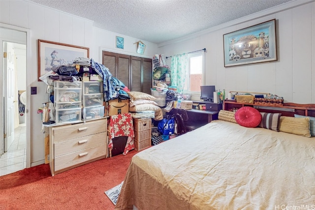 bedroom with dark colored carpet, a textured ceiling, and a closet