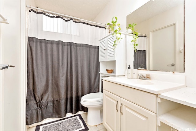 bathroom with curtained shower, a textured ceiling, toilet, tile patterned floors, and vanity