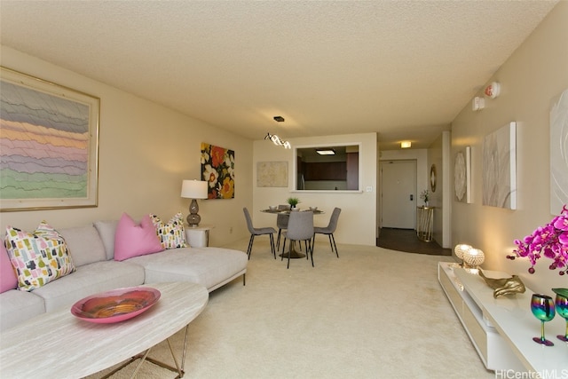 carpeted living room featuring a textured ceiling