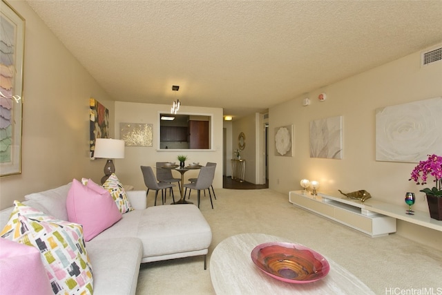 living room with a textured ceiling and carpet floors