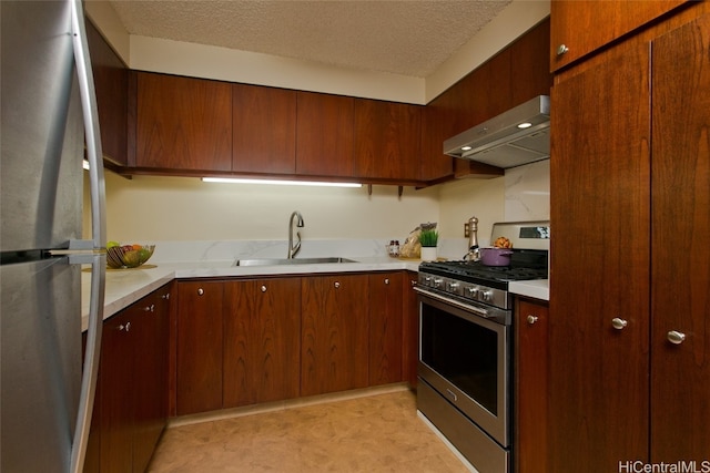 kitchen featuring sink, a textured ceiling, extractor fan, and appliances with stainless steel finishes