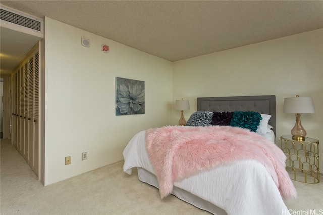 carpeted bedroom with a textured ceiling