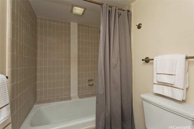 bathroom with toilet and shower / bath combo