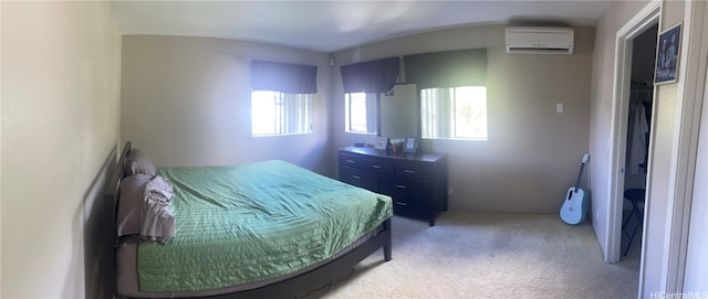 bedroom featuring a wall mounted air conditioner and light carpet