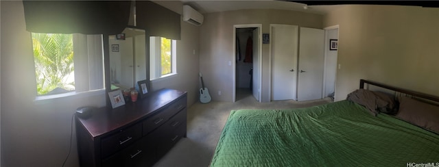 bedroom with a wall unit AC, carpet floors, and a closet