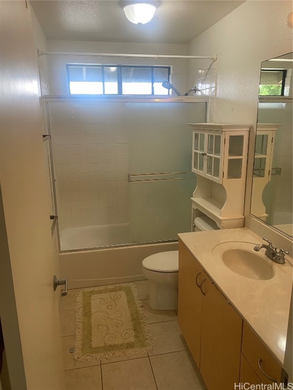 full bathroom featuring vanity, tiled shower / bath combo, toilet, and tile patterned flooring