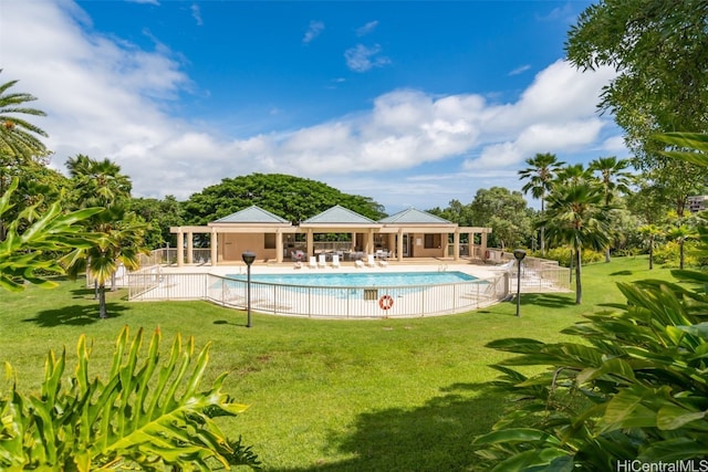 view of pool with a patio area and a lawn