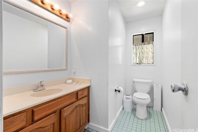 bathroom featuring tile patterned floors, vanity, and toilet