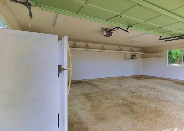 garage with white fridge and a garage door opener