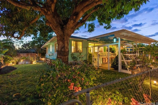 property exterior at dusk with a yard