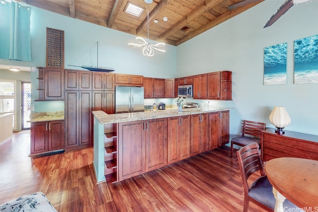 kitchen featuring high vaulted ceiling, dark hardwood / wood-style flooring, wood ceiling, stainless steel appliances, and beam ceiling