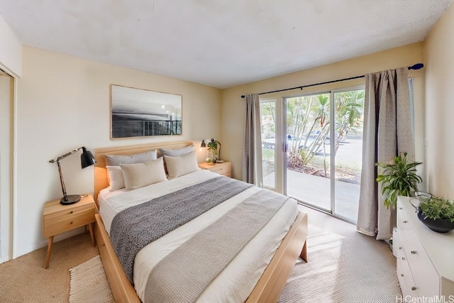 bedroom featuring light colored carpet and access to exterior