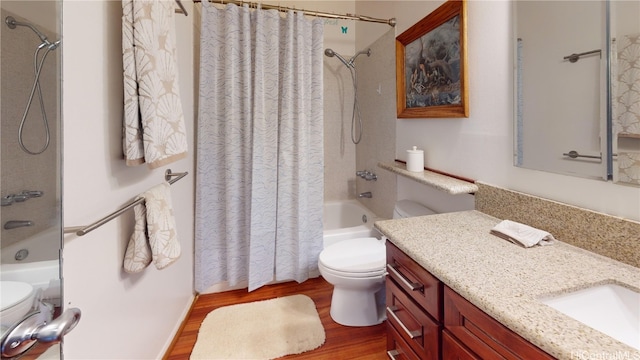 bathroom featuring vanity, shower / tub combo, wood finished floors, and toilet