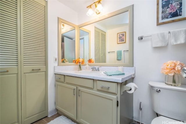 bathroom with vanity, toilet, and tile patterned flooring