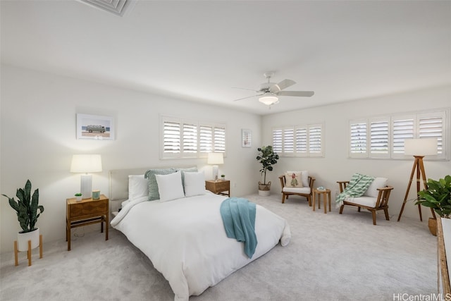 bedroom with light carpet and ceiling fan