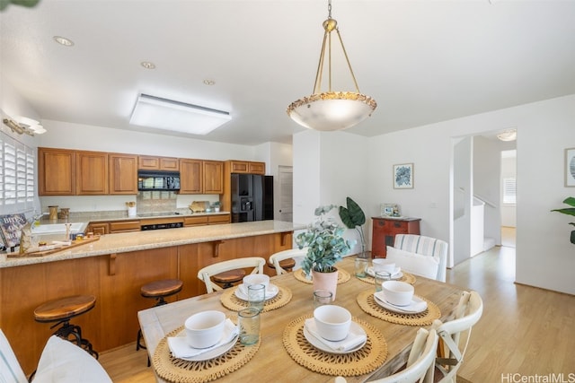 dining space with light wood-style flooring